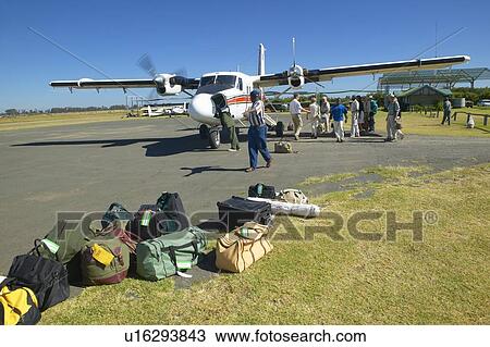 Stock Image - Airplane on landing strip. Fotosearch