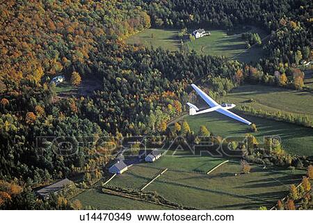 Stock Photo - An aerial glider flies over Warren, Vermont in autumn. Fotosearch