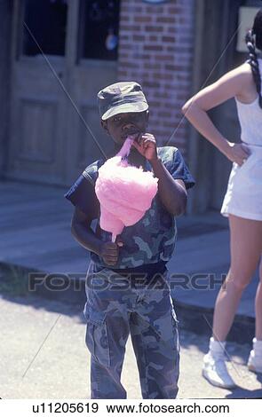 An African-American boy eating cotton candy View Large Photo Image Stock Photo - An African-American boy eating cotton candy. Fotosearch