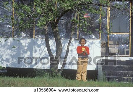 An African-American girl holding an America flag View Large Photo Image Picture - An African-American girl holding an America flag. Fotosearch