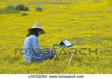 Picture - An artist sketching spring flower fields. Fotosearch