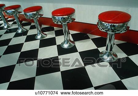 Art deco restaurant with checkered floor and red stools View Large Photo Image Picture - Art deco restaurant with checkered floor and red stools. Fotosearch