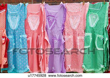 Stock Photo - Brightly colored dresses on display. Fotosearch