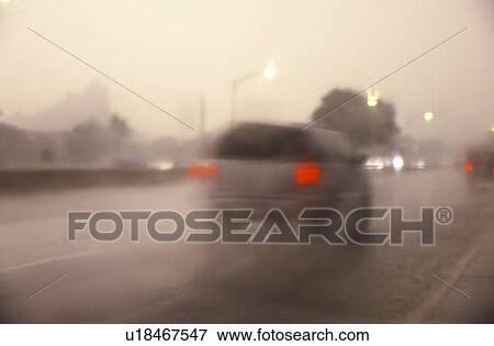 Cars traveling through a thunderstorm and traffic View Large Photo Image Stock Photo - Cars traveling through a thunderstorm and traffic. Fotosearch