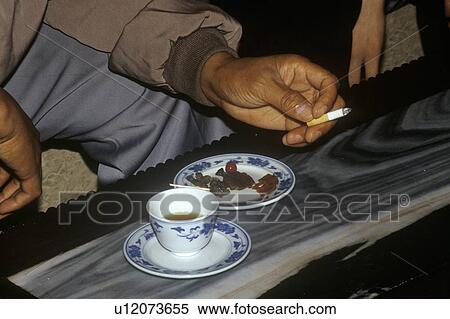 Chinese businessmen smoking on a tour boat View Large Photo Image Stock Photography - Chinese businessmen smoking on a tour boat. Fotosearch