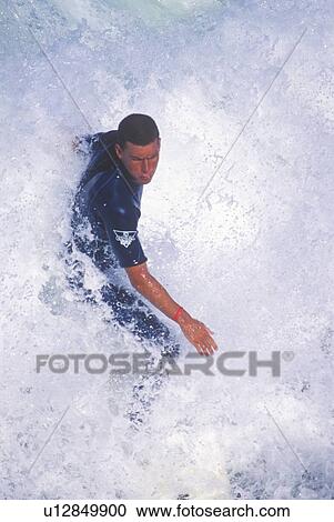Stock Image - Close-up of surfer in wave. Fotosearch