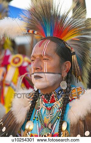 Stock Image - Close-up portrait of Native American in full regalia dancing at Pow wow. Fotosearch