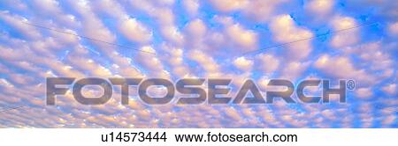 Clouds against a Blue Sky View Large Photo Image Picture - Clouds against a Blue Sky. Fotosearch