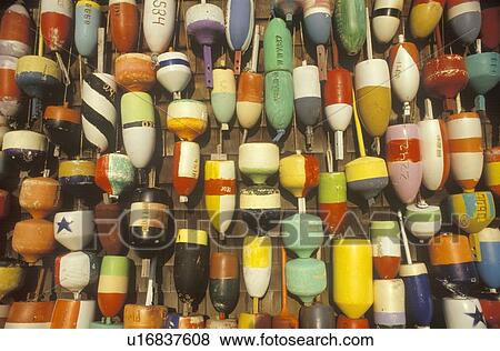 Stock Photo - Colorful buoys displayed on wall. Fotosearch