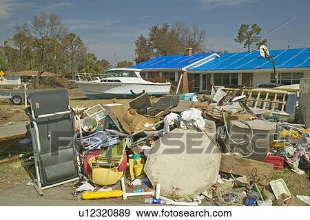Debris in front of house heavily hit by Hurricane Ivan in Pensacola Florida View Large Photo Image Stock Photo - Debris in front of house heavily hit by Hurricane Ivan in Pensacola Florida. Fotosearch