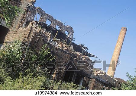 Decaying brick building and smokestack View Large Photo Image Picture - Decaying brick building and smokestack. Fotosearch