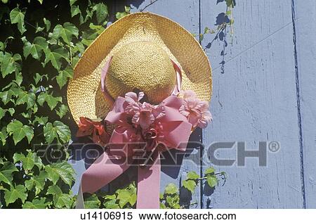 Stock Photography - Decorated straw hat nailed onto a door. Fotosearch