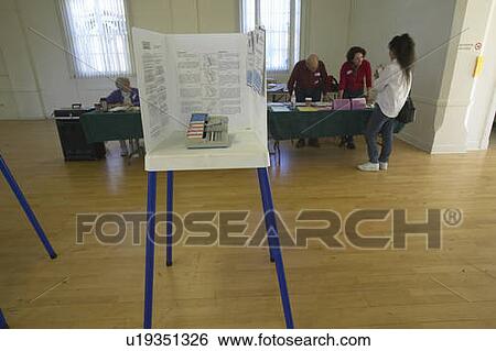 Election volunteers and voting booths in a polling place View Large Photo Image Stock Photograph - Election volunteers and voting booths in a polling place. Fotosearch