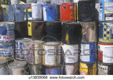 Stock Photo - Empty paint cans waiting for disposal. Fotosearch