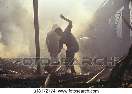 Family salvaging possessions after riots View Large Photo Image Picture - Family salvaging possessions after riots. Fotosearch