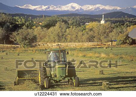 Farm machinery mowing in field View Large Photo Image Stock Image - Farm machinery mowing in field. Fotosearch
