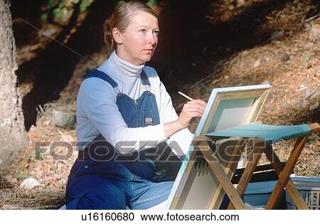 Female artist painting on canvas View Large Photo Image Stock Image - Female artist painting on canvas. Fotosearch