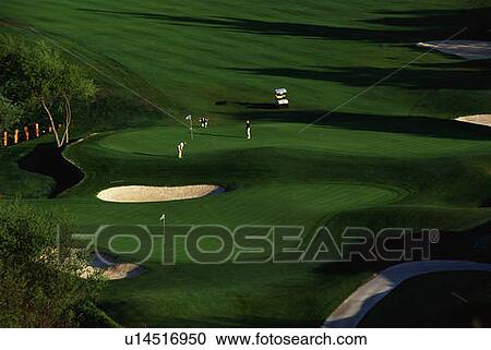 Stock Image - Golf Course with Golfers. Fotosearch