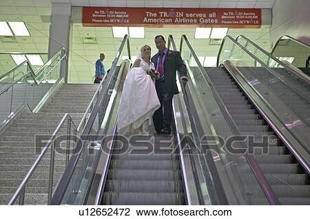 Stock Image - Groom and Bride in airport. Fotosearch
