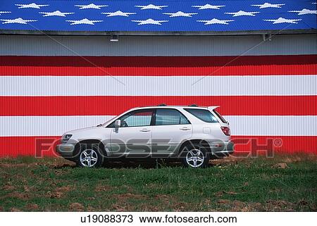 Stock Image - Joe Sohm's RX300 Lexus in front of a barn painted in red, white and blue for the American Flag. Fotosearch