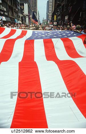 Stock Image - Large U. S. flag at parade, New York City. Fotosearch