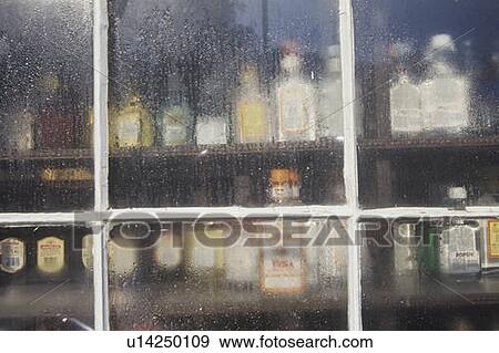 Stock Photo - Liquor in a storefront window, Stockbridge, MA. Fotosearch
