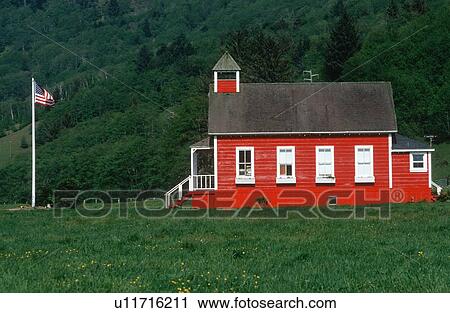 Stock Image - Little Red Schoolhouse with American flag. Fotosearch
