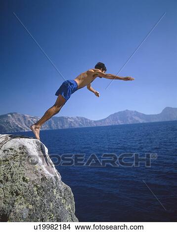 Picture - Man diving into Crater Lake, Oregon. Fotosearch