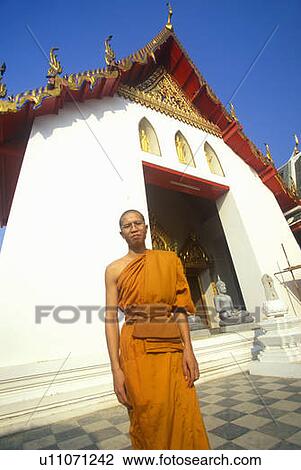 Stock Image - Monk at Buddhist Temple in Bangkok, Thailand. Fotosearch