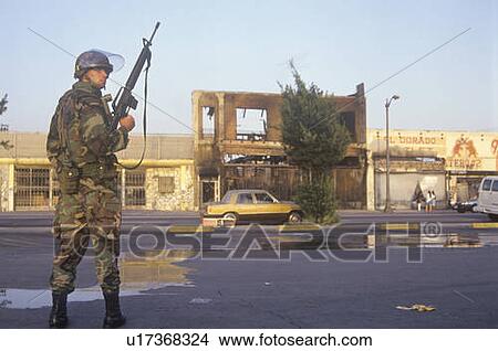 National Guardsman patrolling in front of burned business after 1992 riots, South Central Los Angeles, California View Large Photo Image Picture - National Guardsman patrolling in front of burned business after 1992 riots, South Central Los Angeles, California. Fotosearch