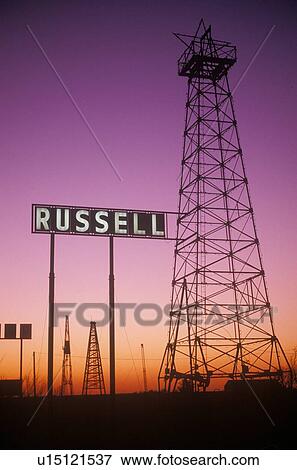 Stock Photo - Obsolete oil rigs at sunset, Russell, KS. Fotosearch