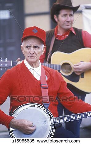 Stock Photography - Old time banjo player performing at a street fair. Fotosearch