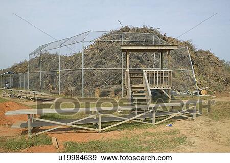 Stock Photo - Pile of storm debris in sport's field from Hurricane Ivan . Fotosearch