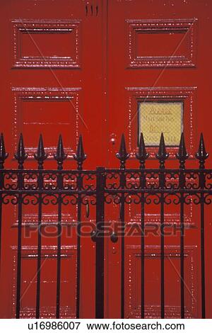 Stock Photo - Red door and wrought iron gate. Fotosearch
