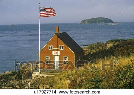 Picture - Red lobster shack overlooking the ocean with American flag. Fotosearch