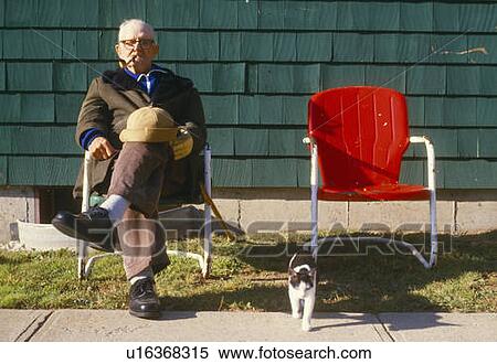 Stock Photography - Senior man in chair smoking a pipe. Fotosearch
