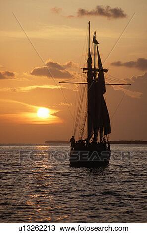 Ship silhouetted at sunset View Large Photo Image Stock Image - Ship silhouetted at sunset. Fotosearch