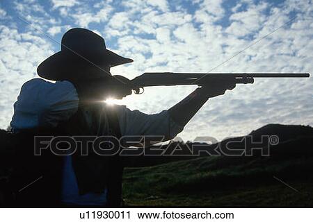 Silhouette of cowboy shooting rifle View Large Photo Image Stock Image - Silhouette of cowboy shooting rifle . Fotosearch