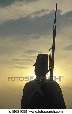 Stock Photography - Silhouette of soldier at sunset with gun during reenactment of Battle of Manassas. Fotosearch