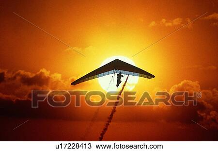 Silhouette of stunt hang glider in the sunset View Large Photo Image Stock Image - Silhouette of stunt hang glider in the sunset. Fotosearch