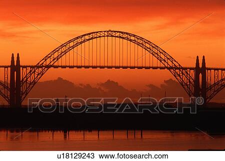 Stock Image - Silhouetted bridge at sunset in Newport, Oregon. Fotosearch