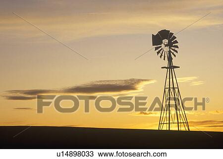 Silhouetted wooden windmill at sunset View Large Photo Image Stock Image - Silhouetted wooden windmill at sunset. Fotosearch