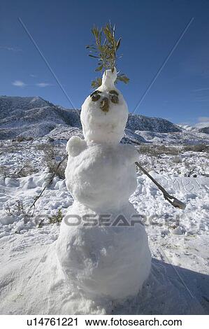 Stock Image - Snowman in fresh snowfall along Highway 33 north of Ojai, California. Fotosearch