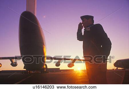 Stock Image - Soldier Saluting by Cargo Plane. Fotosearch
