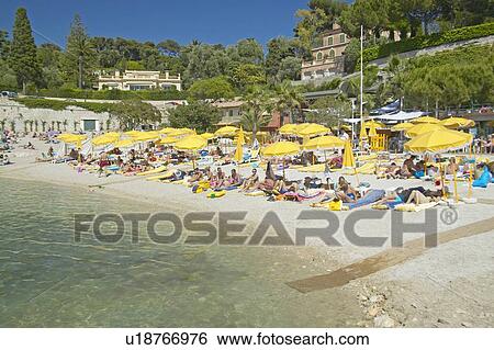 Sunbathers on beach on French Riviera View Large Photo Image Stock Photograph - Sunbathers on beach on French Riviera. Fotosearch