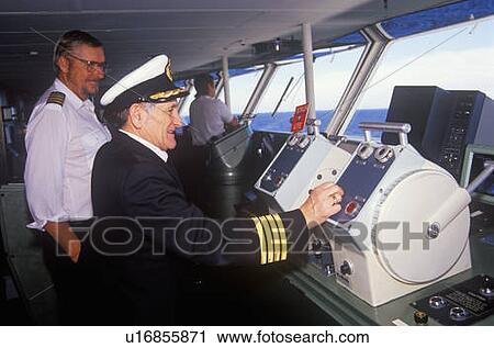 The captain of the ferry Bluenose piloting his boat as a navigator stands by View Large Photo Image Stock Image - The captain of the ferry Bluenose piloting his boat as a navigator stands by. Fotosearch