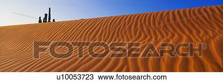 This is Yei Bi Chei and The Totem Pole at sunrise. It is peaking over a sand dune. View Large Photo Image Stock Image - This is Yei Bi Chei and The Totem Pole at sunrise. It is peaking over a sand dune.. Fotosearch