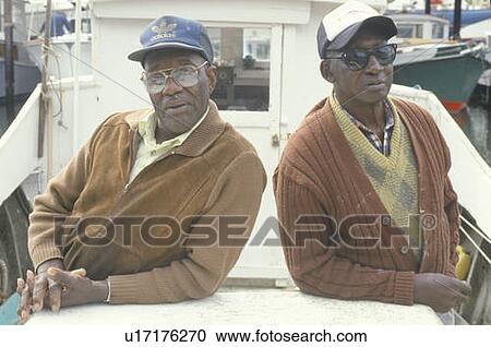 Two African-American men on a boat View Large Photo Image Stock Image - Two African-American men on a boat. Fotosearch