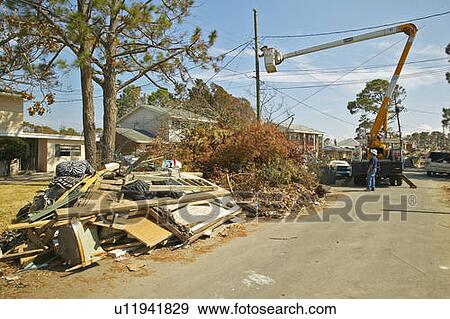 Stock Photo - Utility repairs to suburban homes in Pensacola Florida after Hurricane Ivan storm. Fotosearch