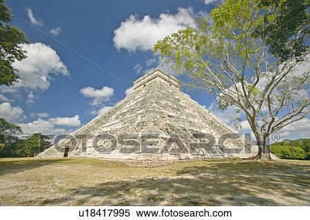 Stock Photography - White puffy clouds over the Mayan Pyramid of Kukulkan. Fotosearch